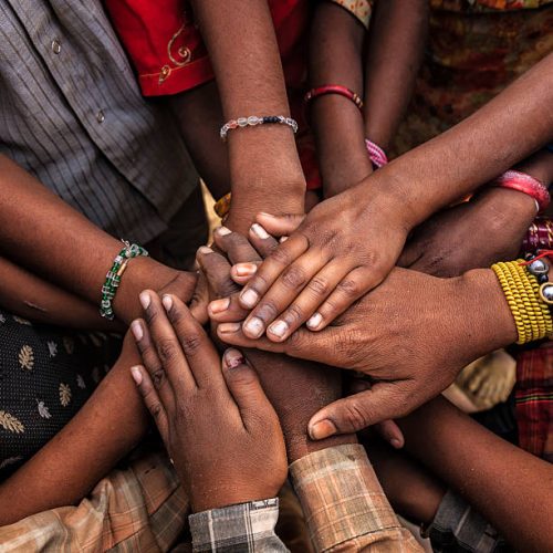Children's hands in one of Indian villages showing unity.